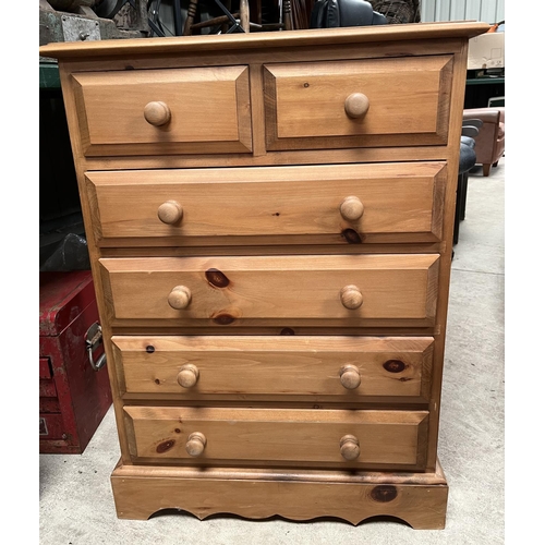 604 - Small pine chest of two short and four long drawers, on shaped skirted base, W66cm D38cm H92cm