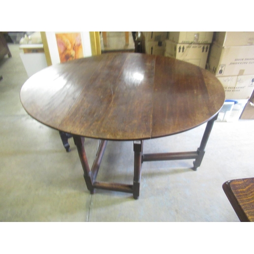 731 - 19th century oval oak gateleg table, D shaped leaves on gun barrel turned and block supports with st... 