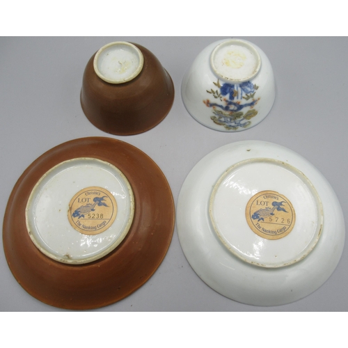 1049 - Two Nanking cargo porcelain tea bowls and saucers, both with tree and floral decoration, cup D7.5cm