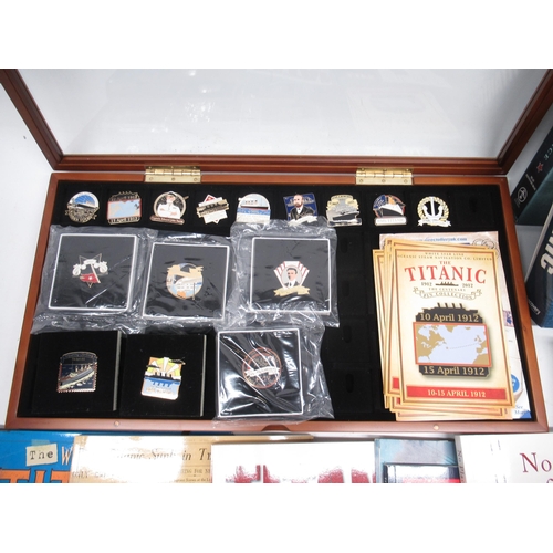 1064 - Collection of Titanic memorabilia incl. display case with fifteen enamel badges, books written by su... 