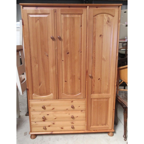 726 - Modern pine combination wardrobe with three doors and three drawers, on bun feet, W122cm D57cm H180c... 