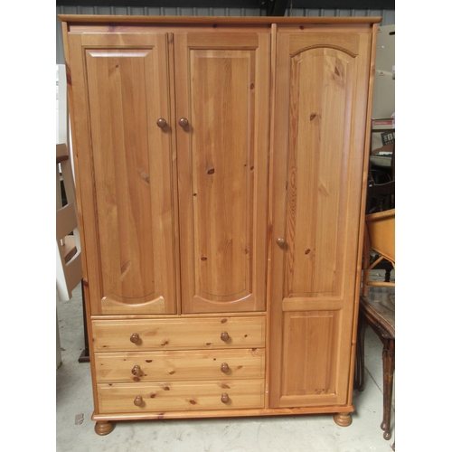 726 - Modern pine combination wardrobe with three doors and three drawers, on bun feet, W122cm D57cm H180c... 