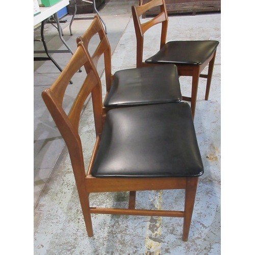 632 - Set of four mid-century teak dining chairs, black upholstered seats on tapered supports, (4)