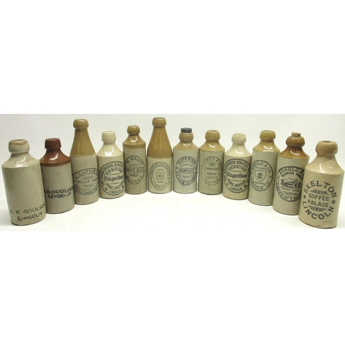 226 - Collection of twelve early 20th century stoneware ginger beer bottles, all from Lincoln