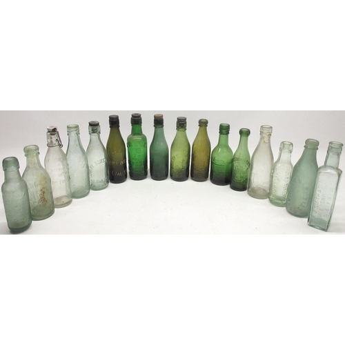 234 - Collection of sixteen glass bottles in green, blue, amber and clear with various makers incl, Tlevet... 