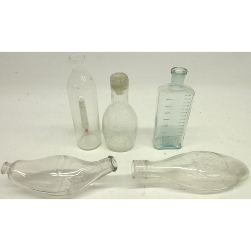 245 - Five glass feeding bottles incl, one with a thermometer, 'Allenbury's' feeder and a C. Wass Chemist ... 