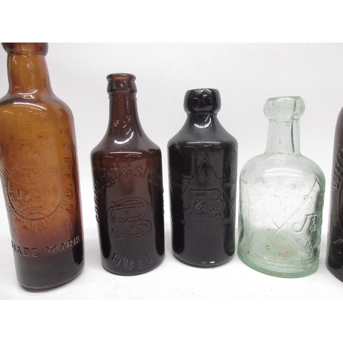 247 - Jewsbury and Brown clear glass soda water bottle and a brown glass ginger beer bottle, both with emb... 