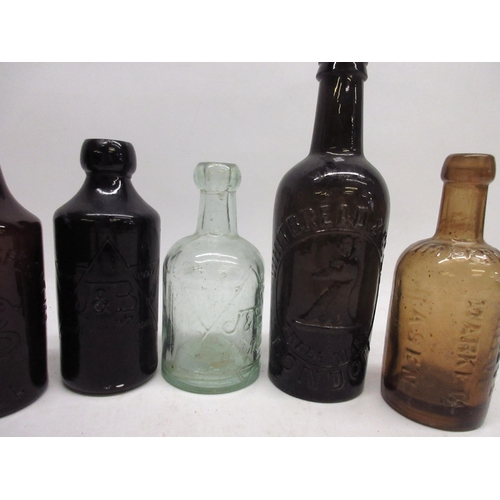 247 - Jewsbury and Brown clear glass soda water bottle and a brown glass ginger beer bottle, both with emb... 