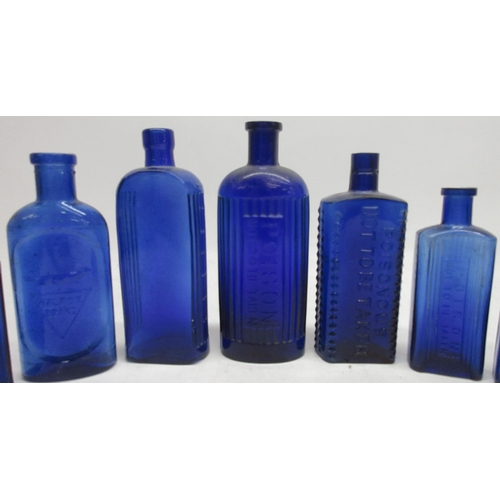 251 - Collection of blue glass poison bottles of various sizes and forms, most with ribbed glass sides