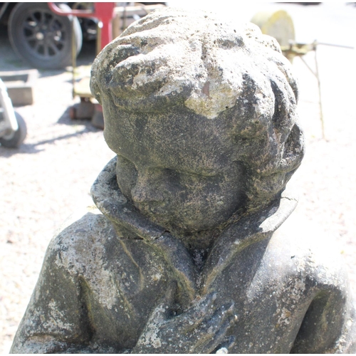 1273 - Reconstitute stone statue of a young man sheltering from the wind, on plinth H120cm