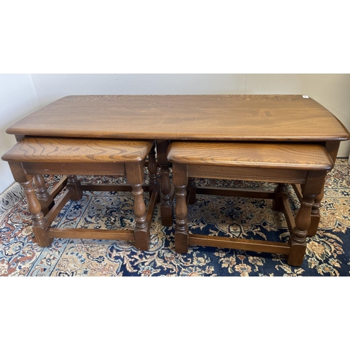 551 - Ercol rectangular dark elm coffee table, with two small nesting tables, the largest H42cm x W112cm x... 