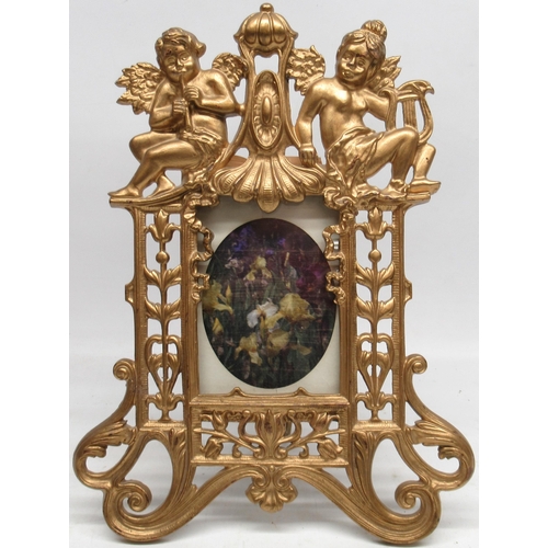 838 - Rococo Revival cast gilt metal photo frame, with cherub cresting and pierced with leafage and scroll... 