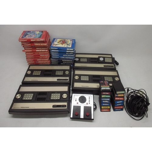 1055 - Four Mattel IntelliVision games consoles, with twenty-four boxed games incl night stalker, space arm... 