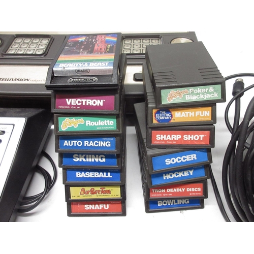 1055 - Four Mattel IntelliVision games consoles, with twenty-four boxed games incl night stalker, space arm... 