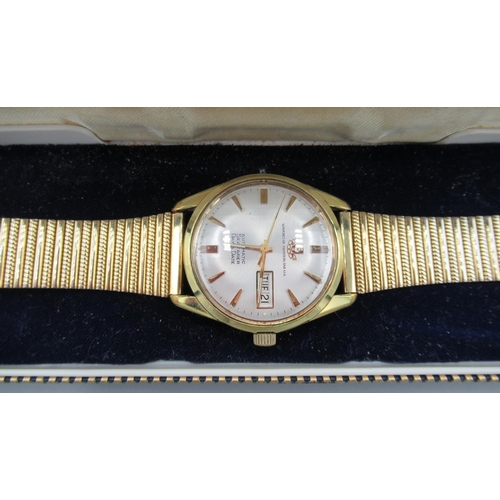 542B - Watches of Switzerland Seafarer gold plated wristwatch with day date, signed silvered sunburst dial,... 