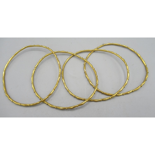 8 - Stack of four yellow metal bamboo style bangles, unmarked, 14.7g