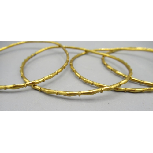 8 - Stack of four yellow metal bamboo style bangles, unmarked, 14.7g