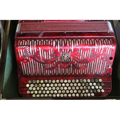 855 - C20th Ca Scandalli Italia, piano accordian, in marbleised red case with mother of pearl button keys ... 