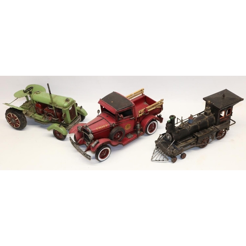 83 - Three decorative American style model vehicles, comprising green tractor, locomotive, and fire truck... 