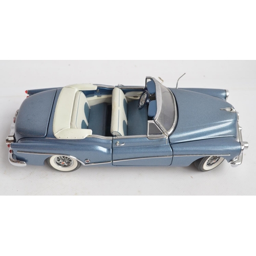 363 - Four boxed 1/24th scale diecast vehicles to include a Franklin Mint 1953 Cadillac Eldorado (model wi... 