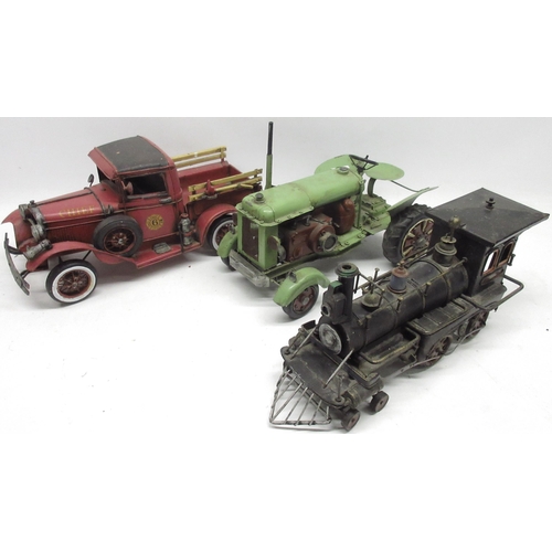 83 - Three decorative American style model vehicles, comprising green tractor, locomotive, and fire truck... 