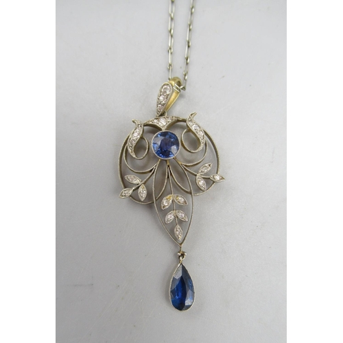 202 - Edwardian yellow and white metal open work drop pendant, set with sapphires and diamonds, on white m... 