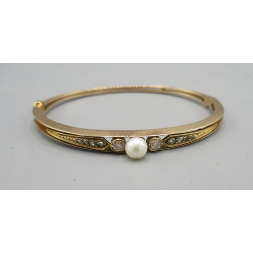 209 - Victorian yellow metal hinged bangle set with single pearl flanked by rose cut diamonds, on diamond ... 