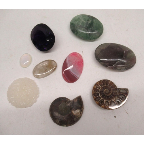 1108 - Amethyst, other large cut gemstones including rhodochrosite, fluorite, carved white jade, an ammonit... 