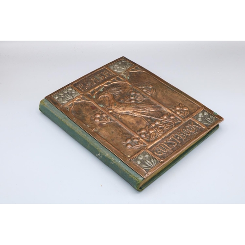 194 - Arts and Crafts copper mounted guest book, the embossed cover decorated with a bird and berries view... 