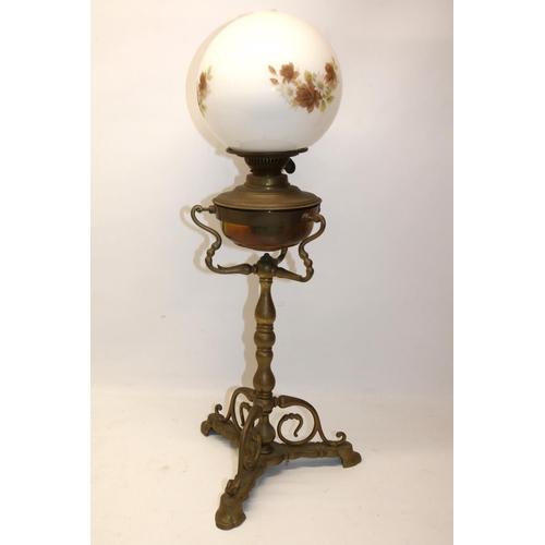 82 - Three footed brass oil lamp with white glass transfer decorated shade, H55cm