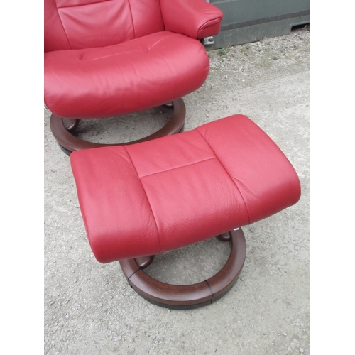 648 - Stressless red leather upholstered arm chair and matching stool