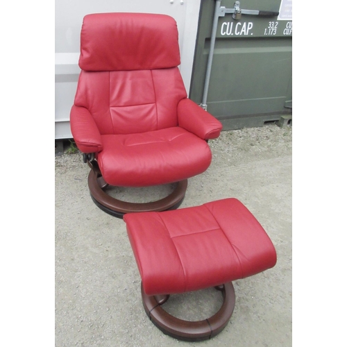 648 - Stressless red leather upholstered arm chair and matching stool