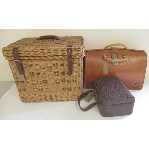 1225 - Wicker picnic basket with fitted interior and leather straps, a Cygnet brown leather brief case and ... 