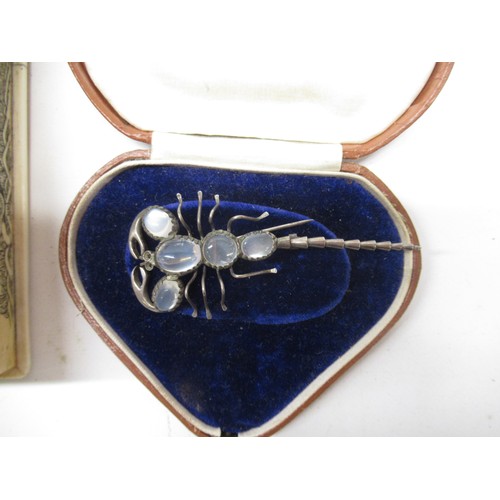 1335 - Julia Bradbury Collection: 20th century white metal and moonstone Scorpion brooch, L8cm, jet type br... 