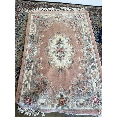 1243 - Salmon ground Chinese rug decorated with flowers and scrolls, 180cm x 120cm