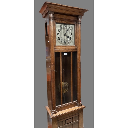 1345 - C20th continental oak long case clock, glazed door and square silvered Arabic dial with twin weight ... 