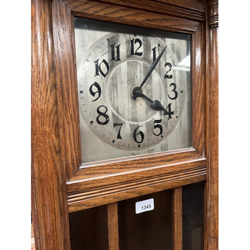 1345 - C20th continental oak long case clock, glazed door and square silvered Arabic dial with twin weight ... 