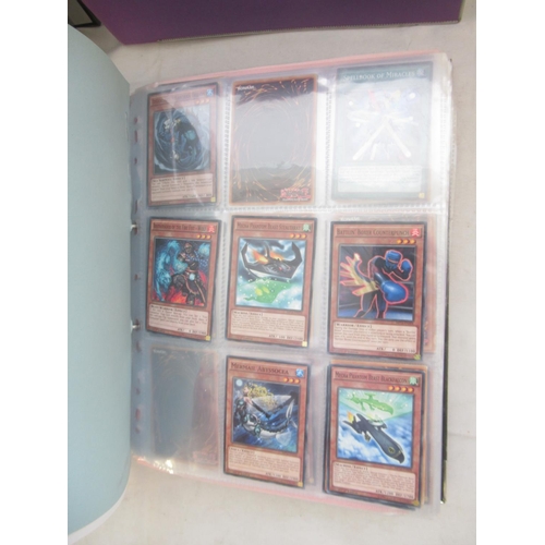 832 - Four folders cont. large collection of Yu-Gi-Ho trading cards