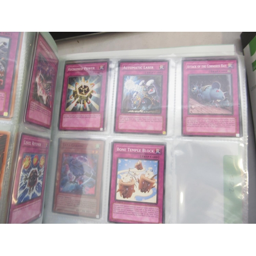 832 - Four folders cont. large collection of Yu-Gi-Ho trading cards