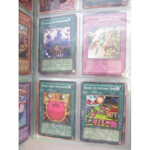 832 - Four folders cont. large collection of Yu-Gi-Ho trading cards