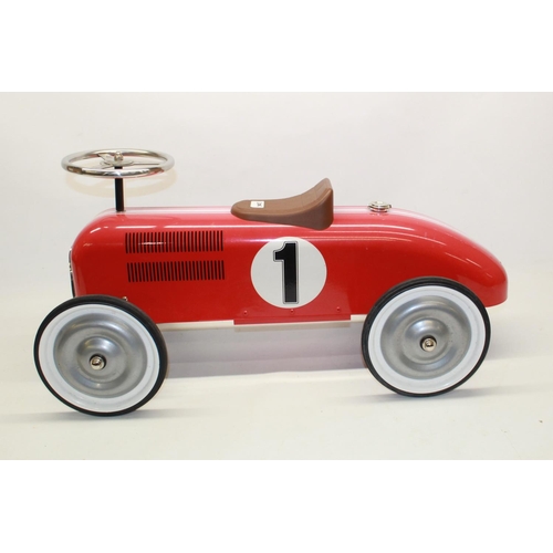 882 - Children's painted ride on tin plate car in the form pre-war Grand Prix racing car, L73cm