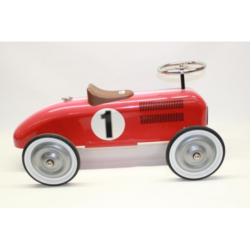 882 - Children's painted ride on tin plate car in the form pre-war Grand Prix racing car, L73cm