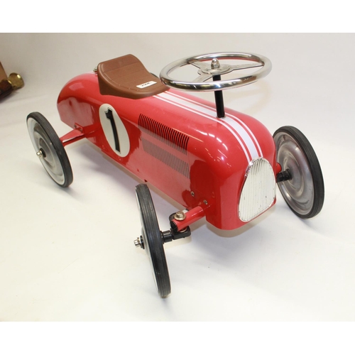 882 - Children's painted ride on tin plate car in the form pre-war Grand Prix racing car, L73cm