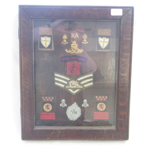 1209 - Framed collection of Regimental badges relating to The Royal Artillery and Argyll and Sutherland.