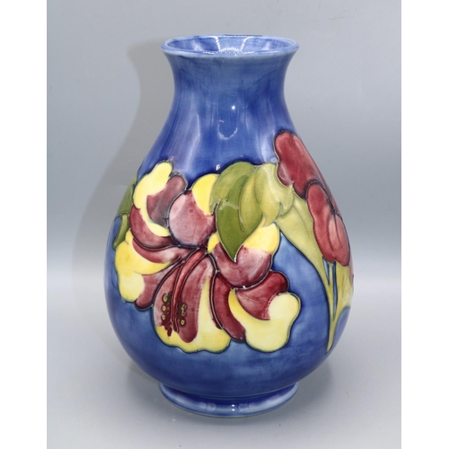 354 - Moorcroft Pottery: Hibiscus pattern baluster vase, red flowers on blue wash ground, Queen Mary stick... 