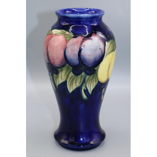 359 - Moorcroft Pottery: Wisteria pattern inverted baluster shape vase, fruit on a dark blue ground, H18.5... 