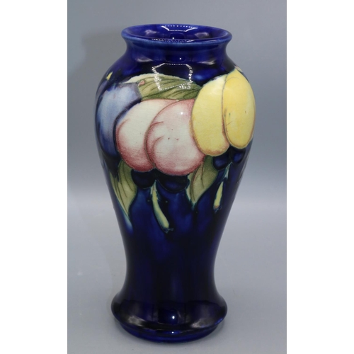 359 - Moorcroft Pottery: Wisteria pattern inverted baluster shape vase, fruit on a dark blue ground, H18.5... 