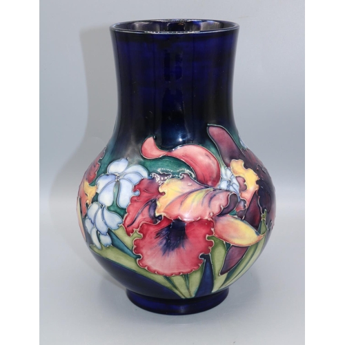 Moorcroft Pottery: Orchid pattern vase, dark blue wash ground, H22cm