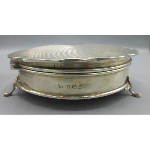 46 - George V silver trinket box with engine turned stripes, circular cartouche, gilt interior with blue ... 