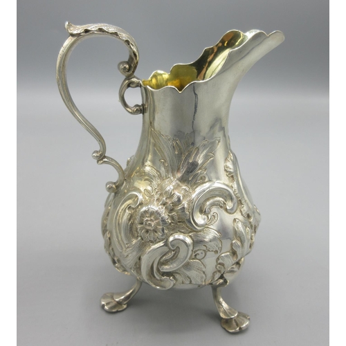 51 - Victorian silver milk jug with floral and scrolling repousse, gilt interior and a scroll handle by C... 